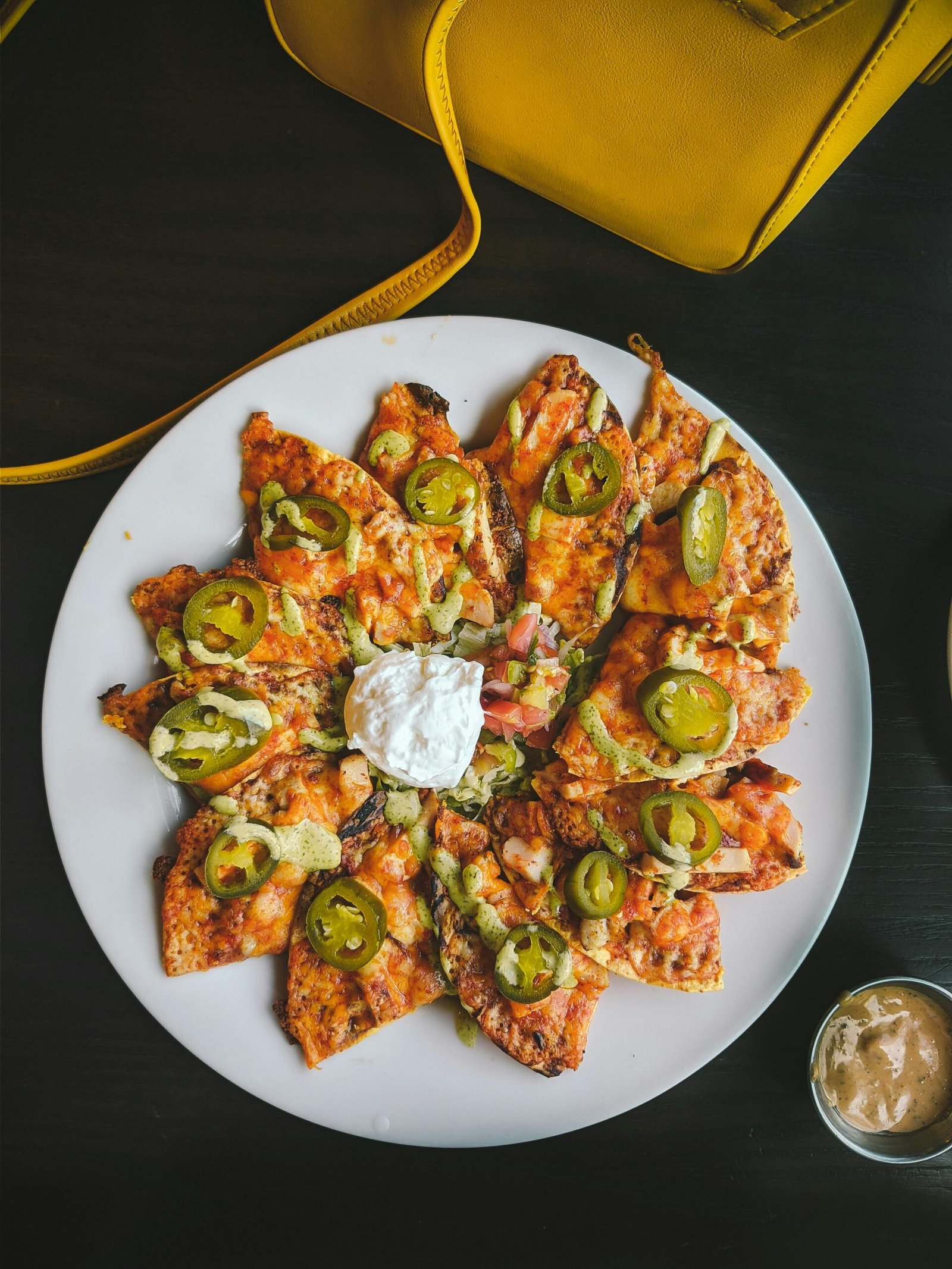 A mouth-watering shot of loaded nachos topped with jalapeños, perfect for Mexican cuisine lovers.