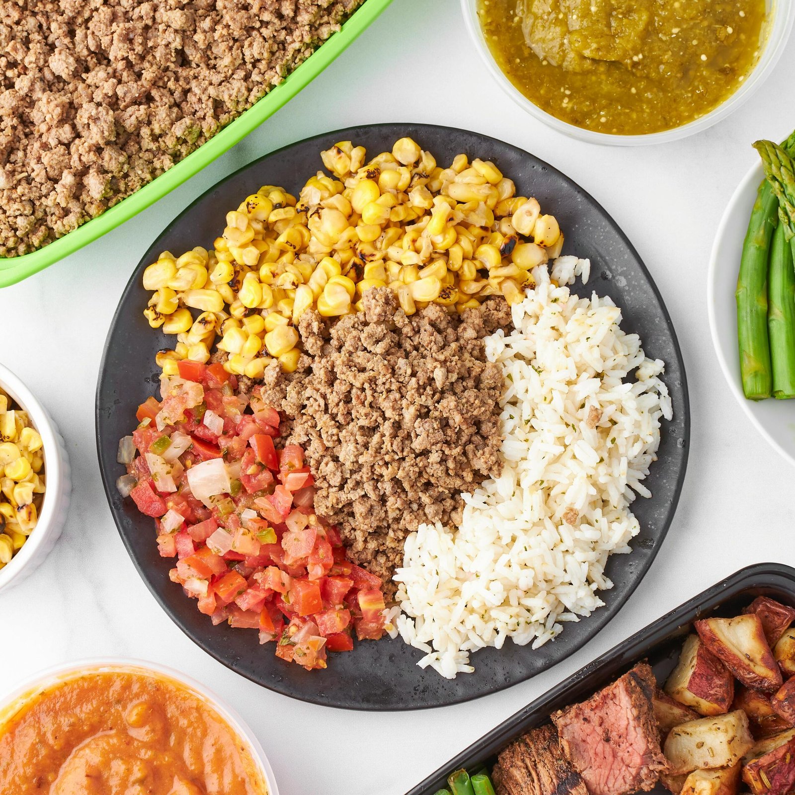Flavorful Mexican-inspired couscous bowl with corn, ground beef, rice, and salsa.